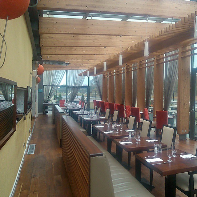 a restaurant with wooden tables and tan walls and floor