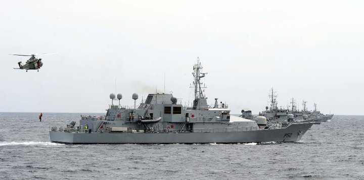 military ships in the ocean with two helicopters