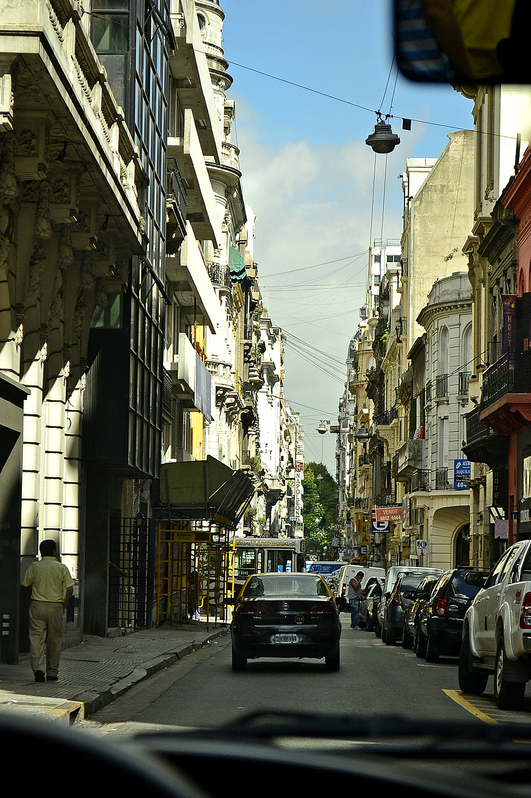 a city street is filled with cars and people