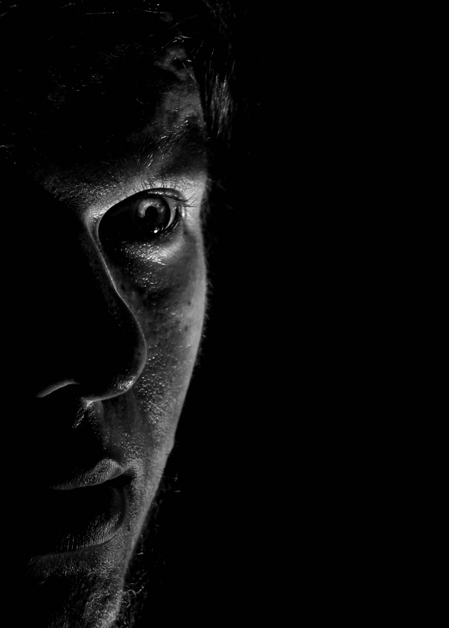 a man's face with a black background