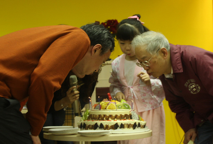 an old couple of people looking at a cake