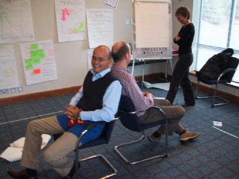 an office meeting where people are happy for the employees