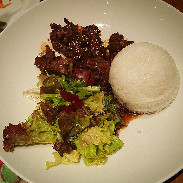 plate of food with meat and salad on the side