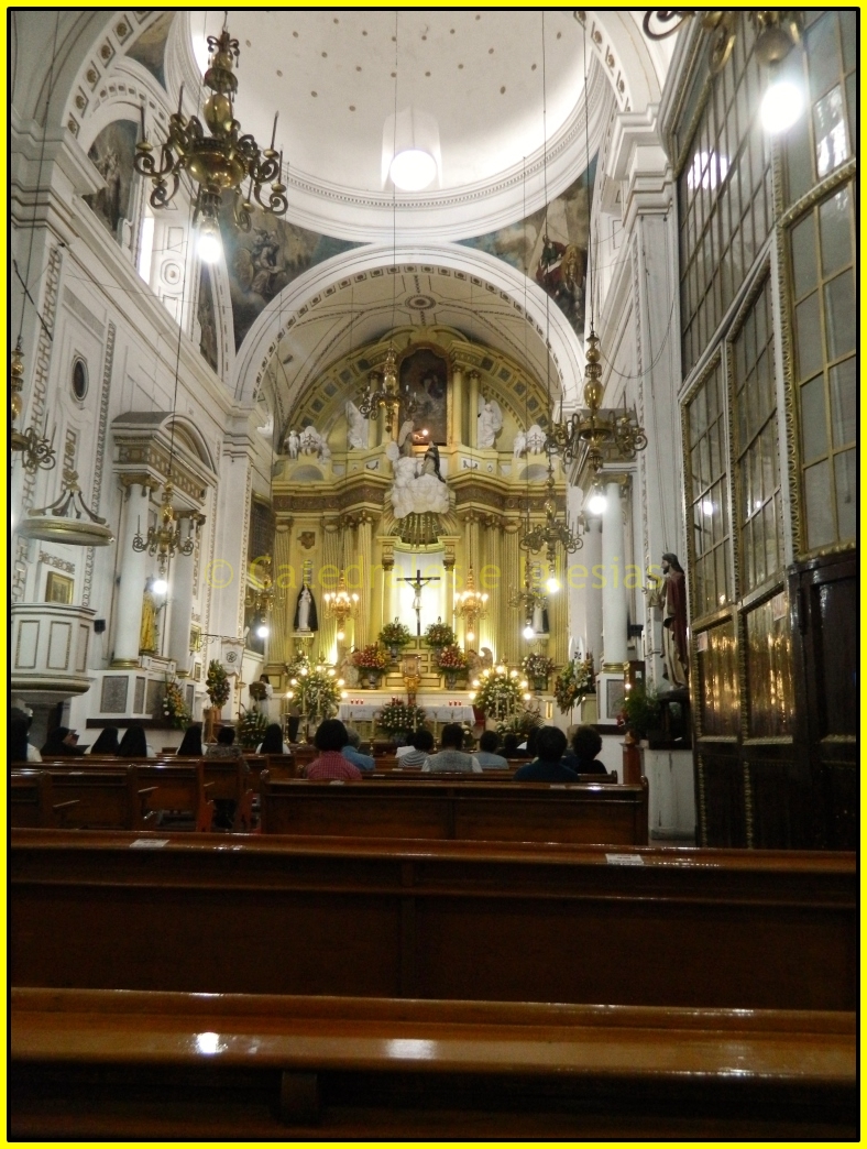 the interior of a church with pews and people inside