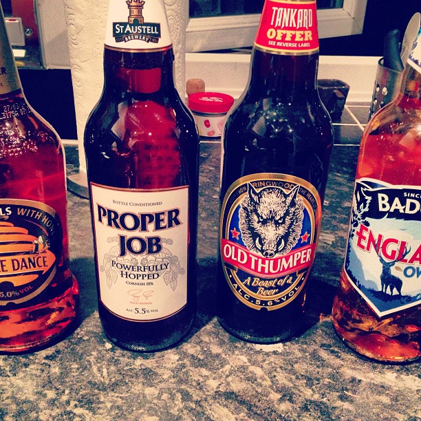 four different sized beer bottles on the counter