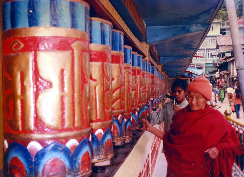 woman in traditional indian garb is next to brightly painted wall