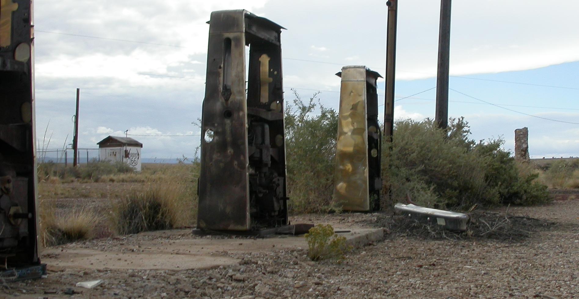 several broken gates and benches sit out on the gravel