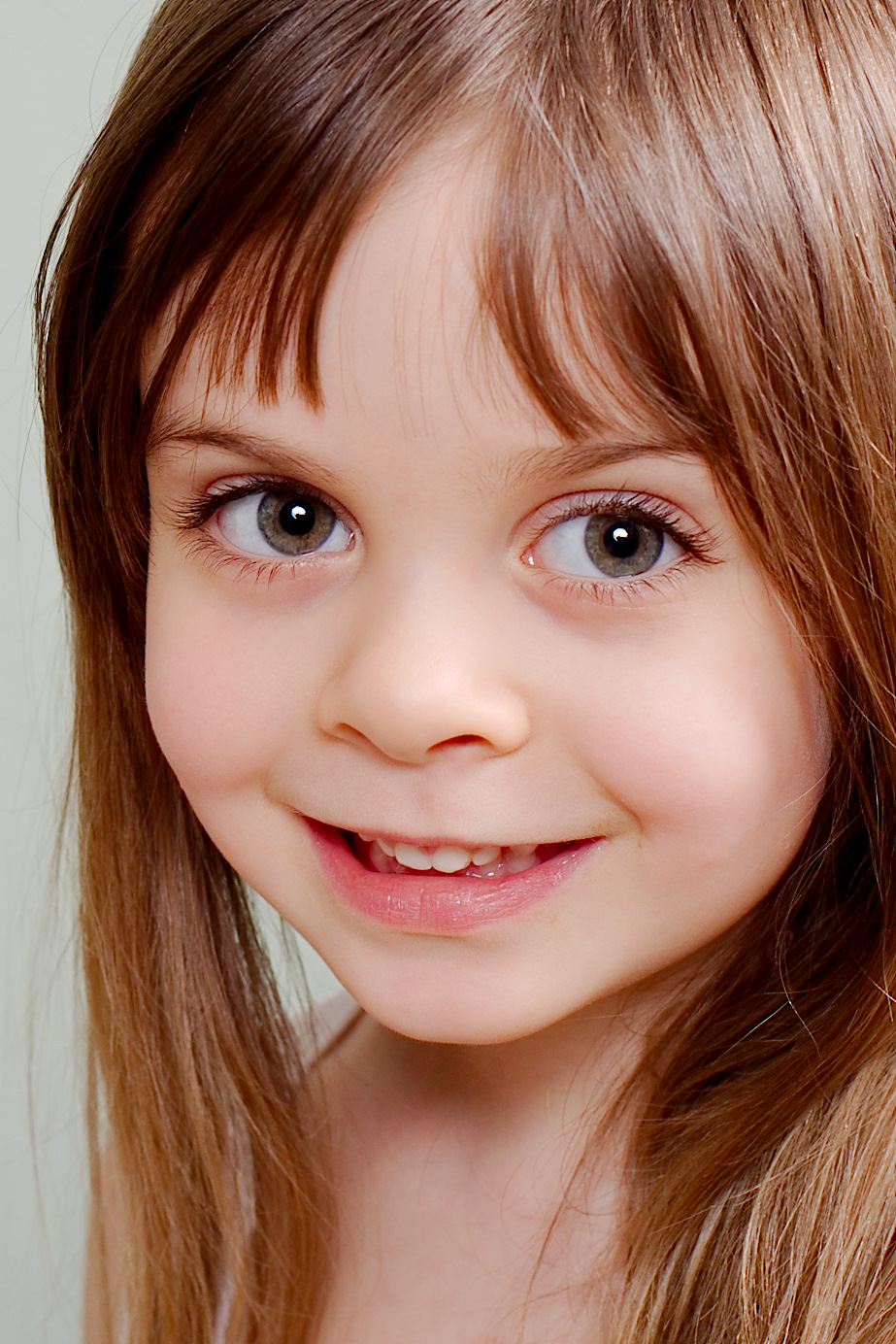 this is a girl with long blond hair smiling