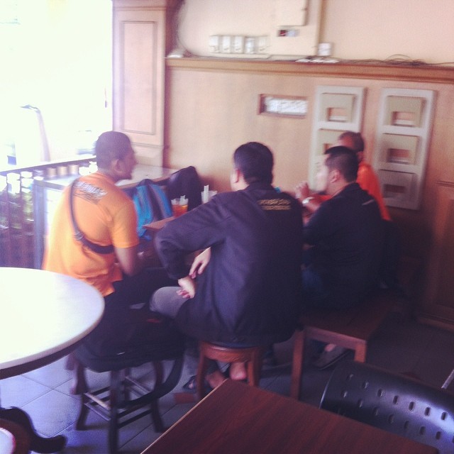 people seated at tables in a small cafe