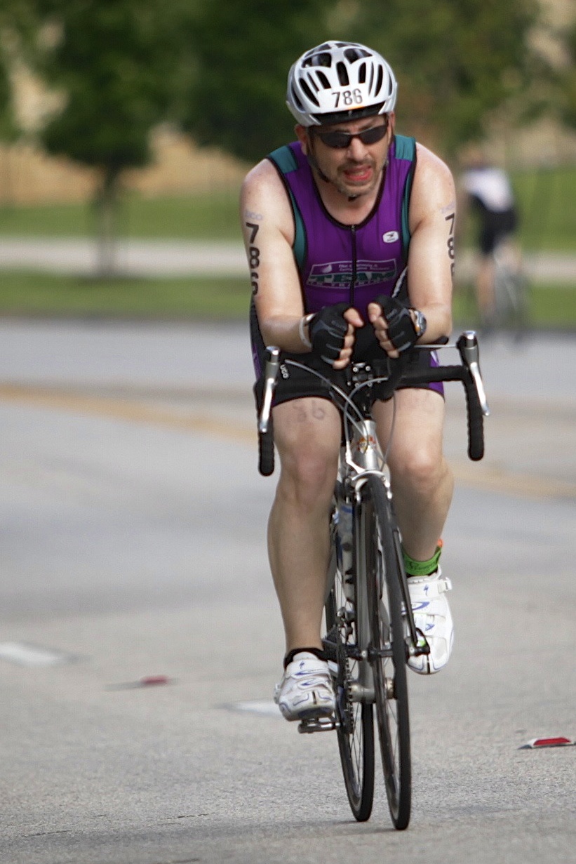 a man riding a bike down the street