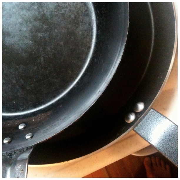 black wok stacked with other plates on top