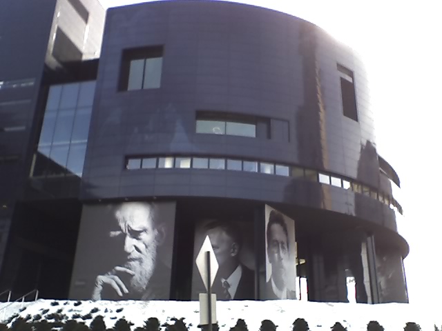 an artistic building with pos of men on the side