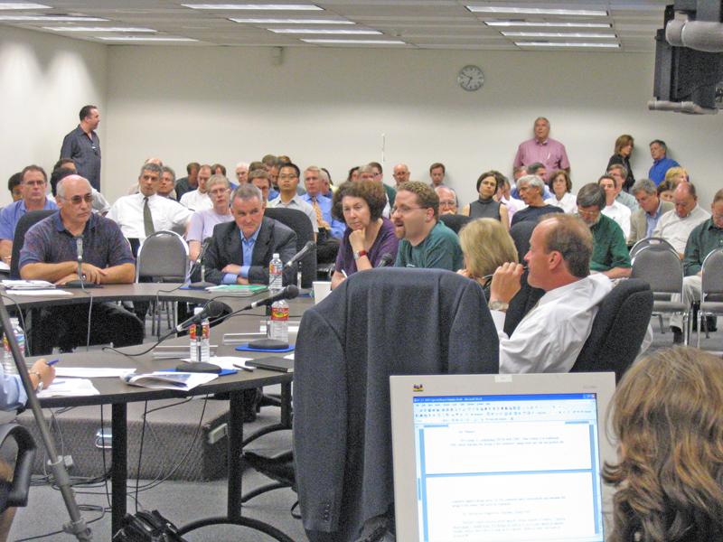 an audience is watching a large conference room