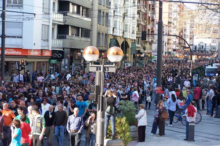 the street is full of people walking by the sidewalk