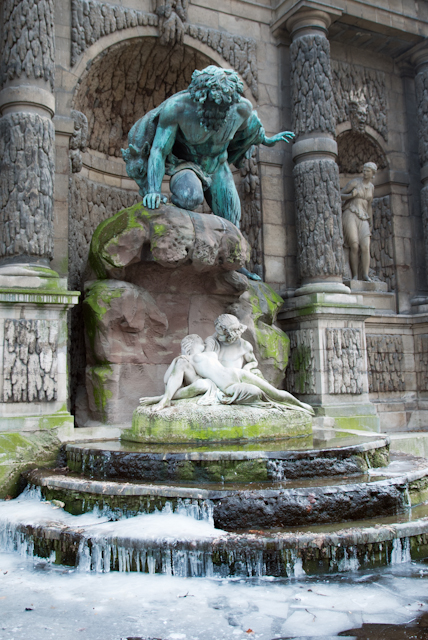 there is a water fountain with a statue on it