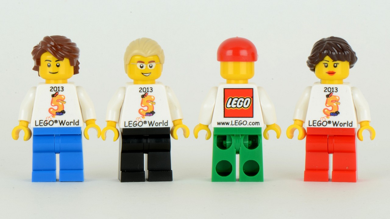 three lego people are standing next to each other