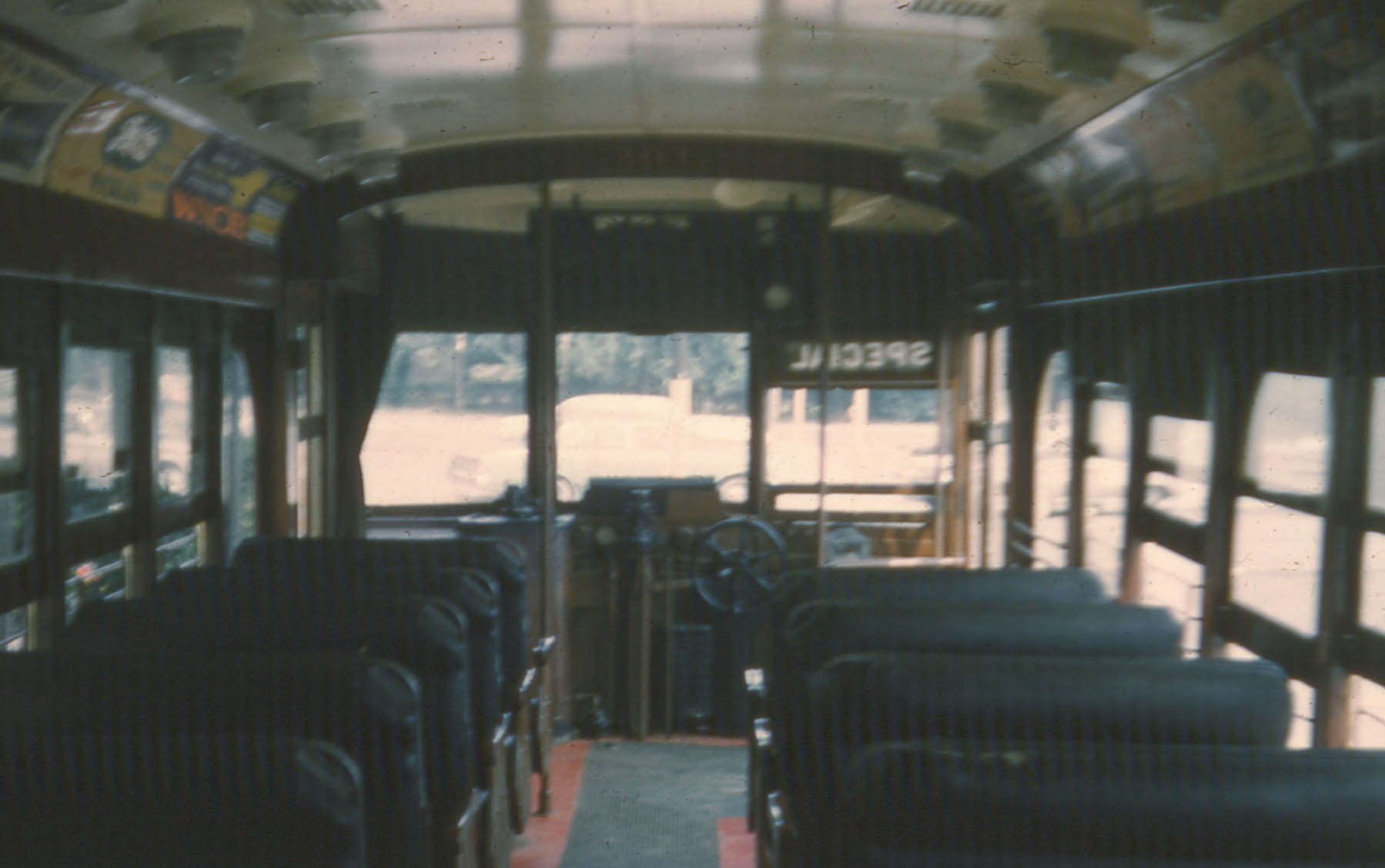 this old po shows a bus with empty seats