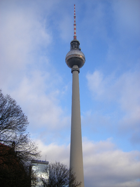 a very tall tower with a spire on the side of it