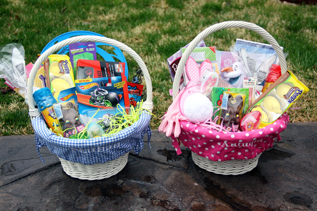 two baskets filled with toys and stuff sitting on top of a rock