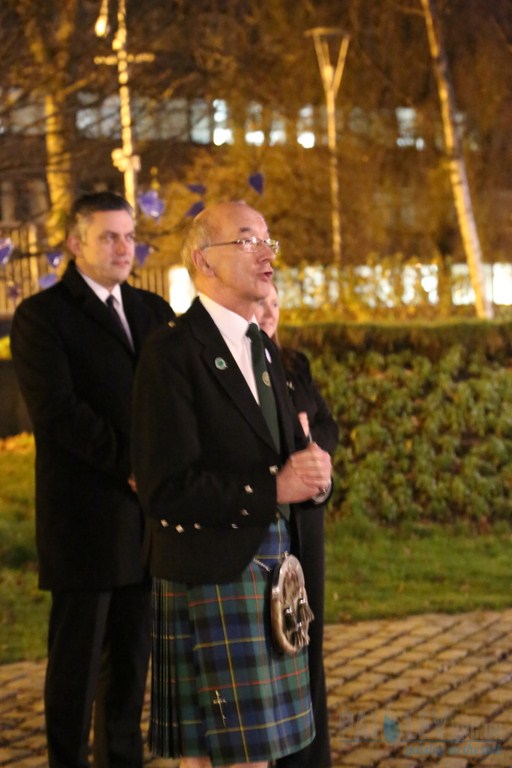 two men wearing kilts posing for the camera