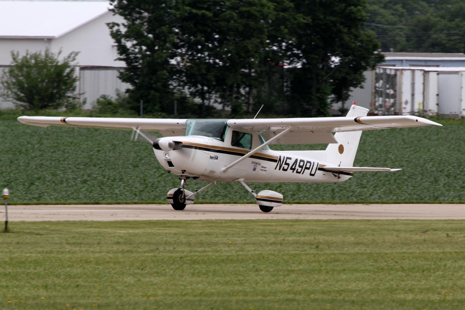 a small white plane sitting on top of an airport runway