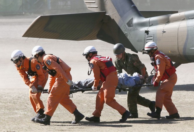 a group of firefighters carry an injured man on a stretcher