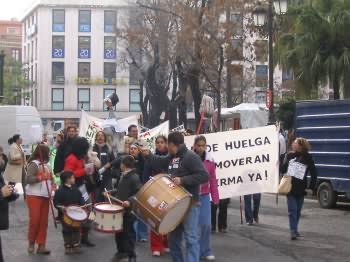 some people are holding drums and marching in the street