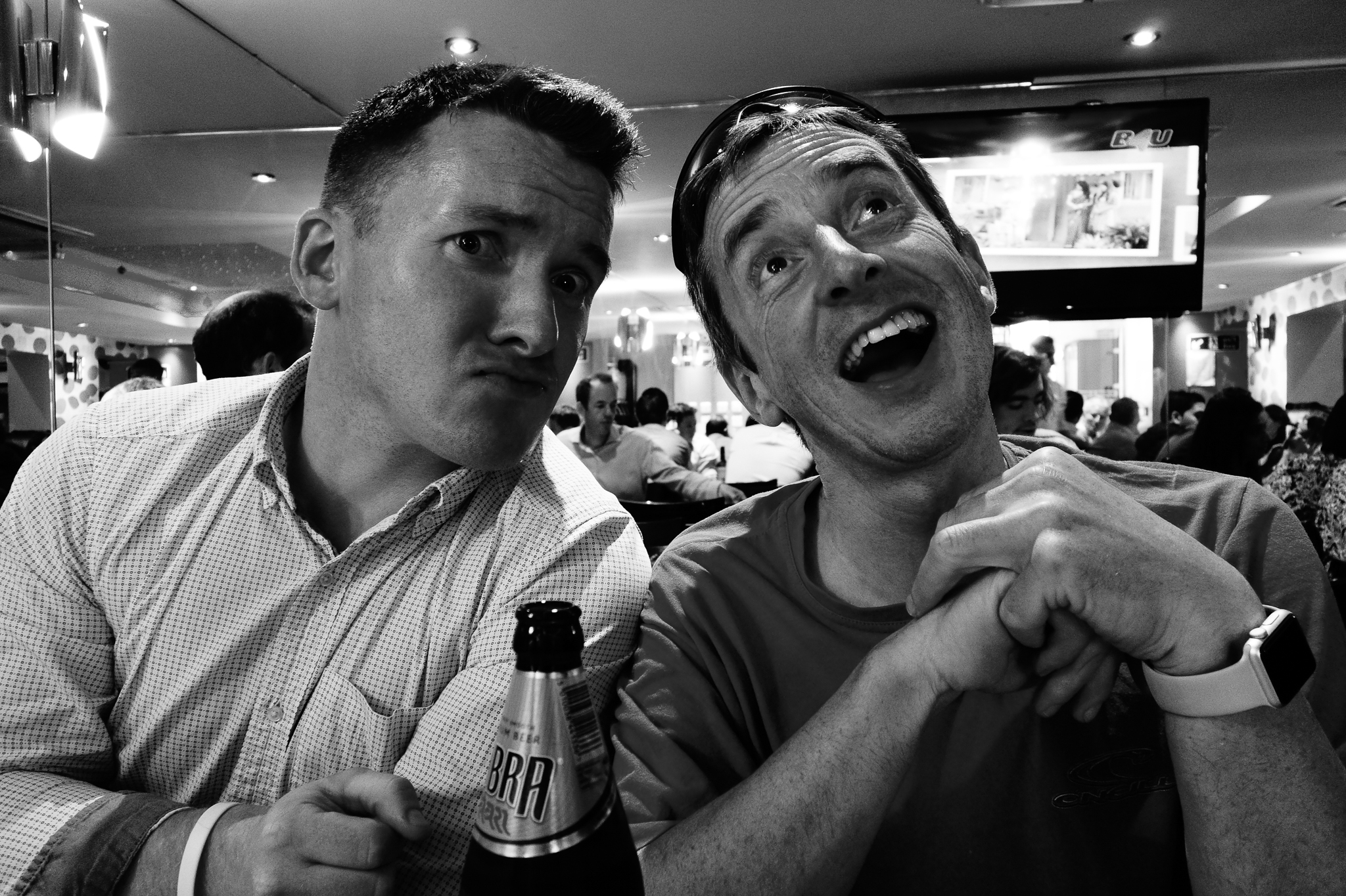 a black and white po of two guys with bottles