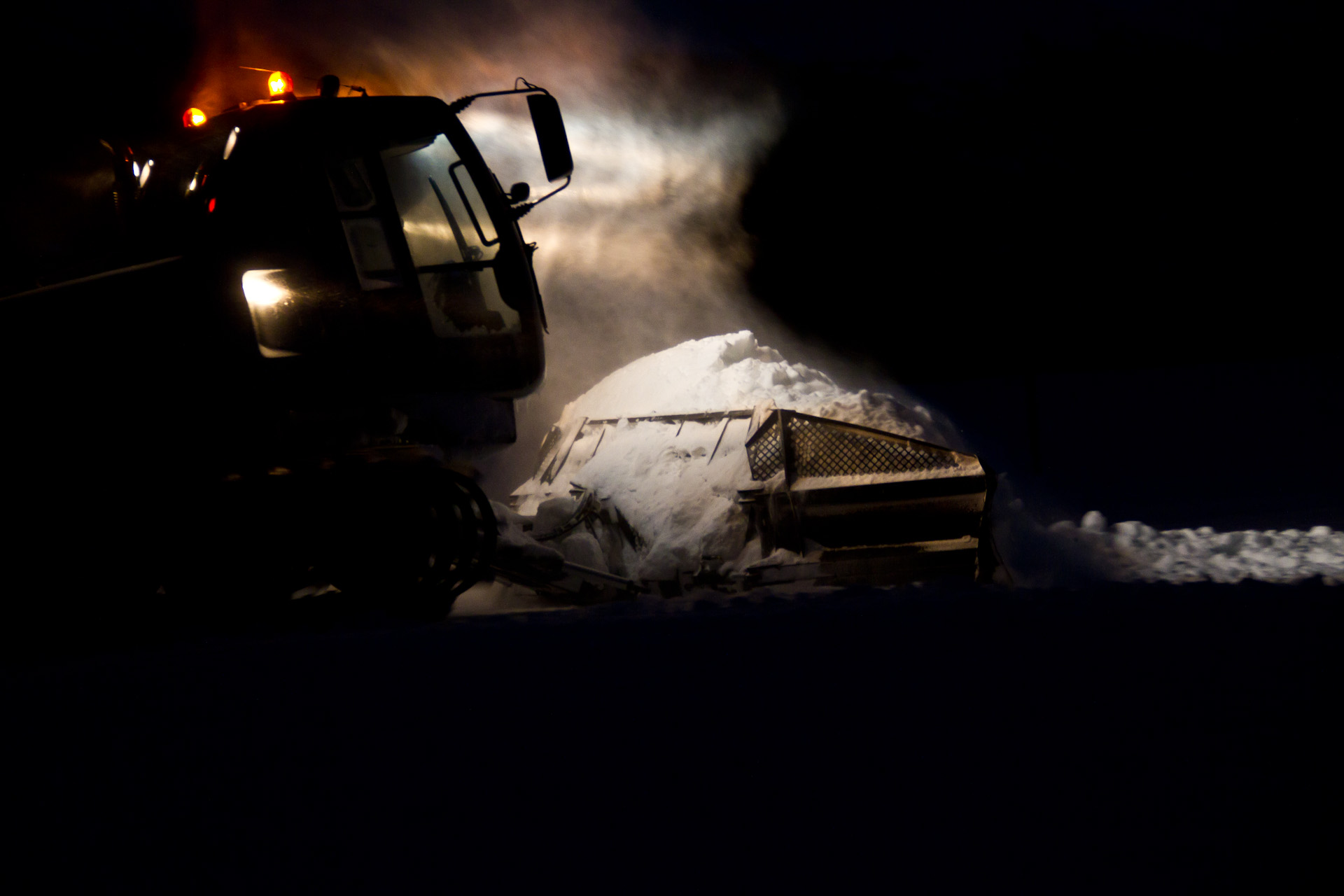 a large truck on snow covered ground next to building