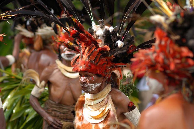 men dressed in african american costumes and headdreses, including feathers