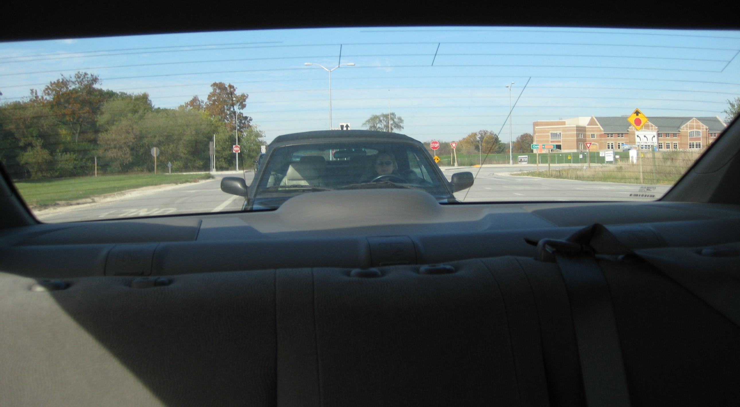 a pickup truck sits parked along a suburban road