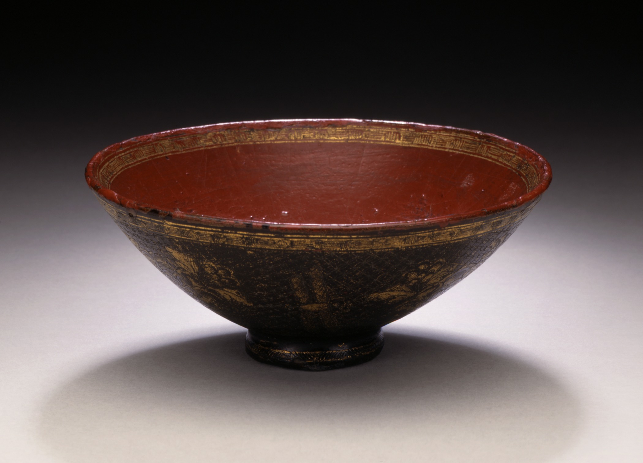 an old brown bowl sitting on a table