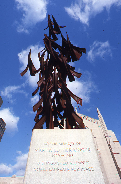 the large metal tree is in front of a building