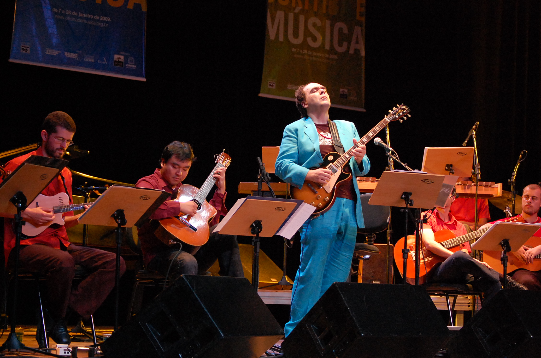 some people with guitars playing on stage