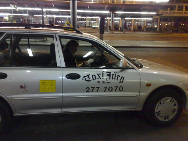 the taxi is white with yellow trim, with black lettering