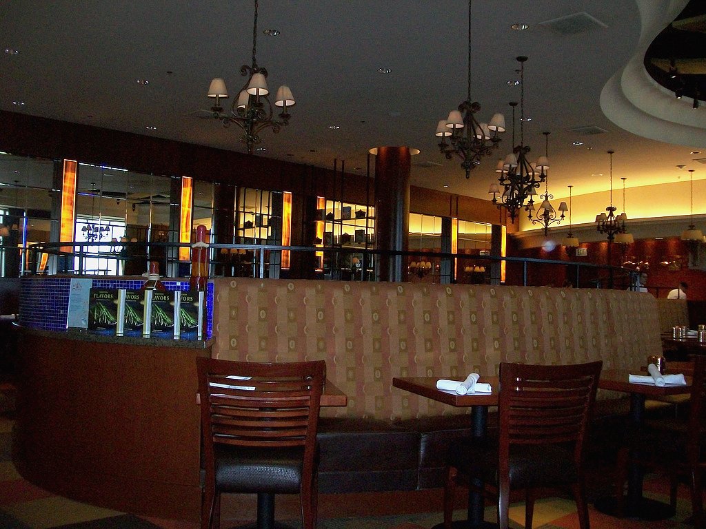 the interior of a restaurant with rows of tables and chairs