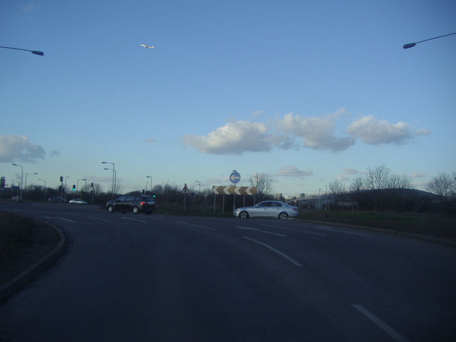 a bunch of vehicles are riding down the road