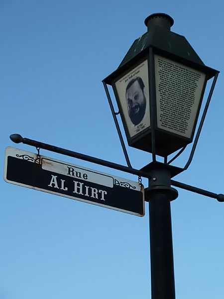 street signs next to street lamp on clear day