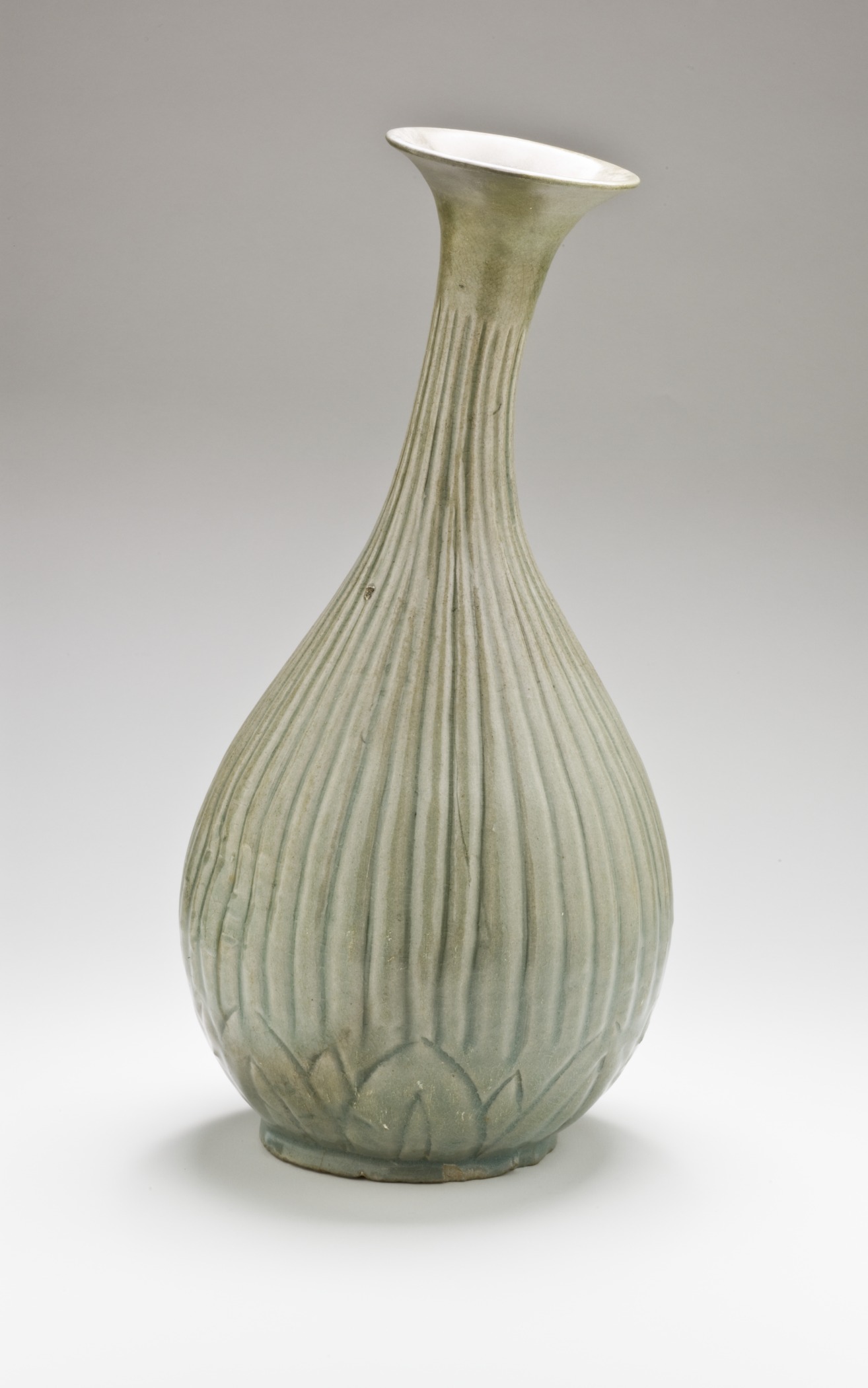 a vase with wavy designs on it in front of a gray background
