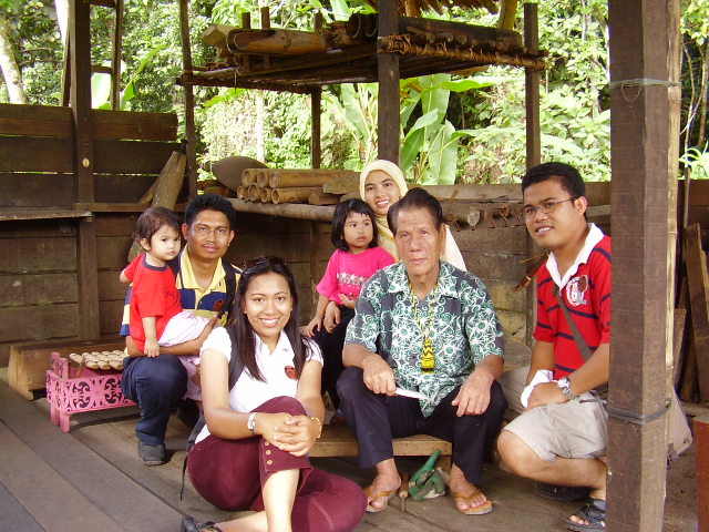 several people sitting on the floor of a wooden shelter