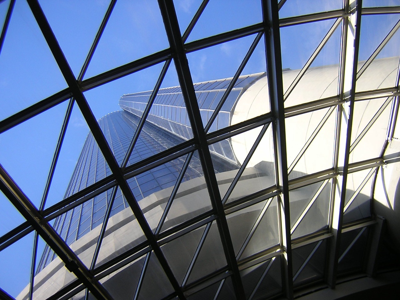 a glass walkway going up into a building