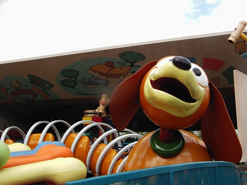 a cartoon dog sitting on top of a large toy