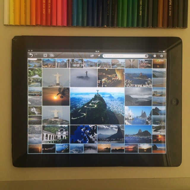 a wall mounted tablet displaying pictures of different places