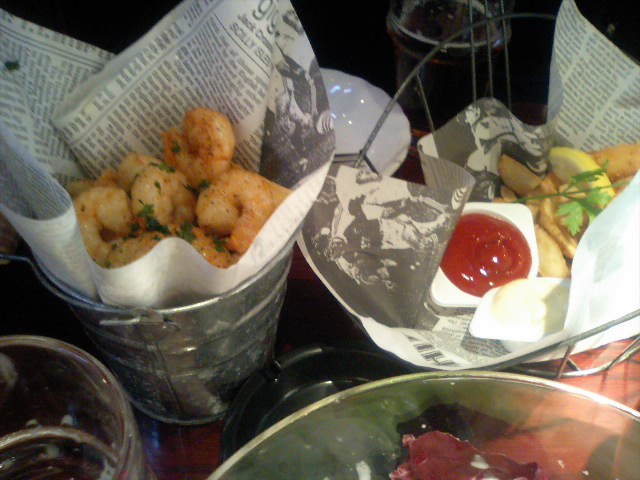 two baskets with  dogs, some salad and a drink