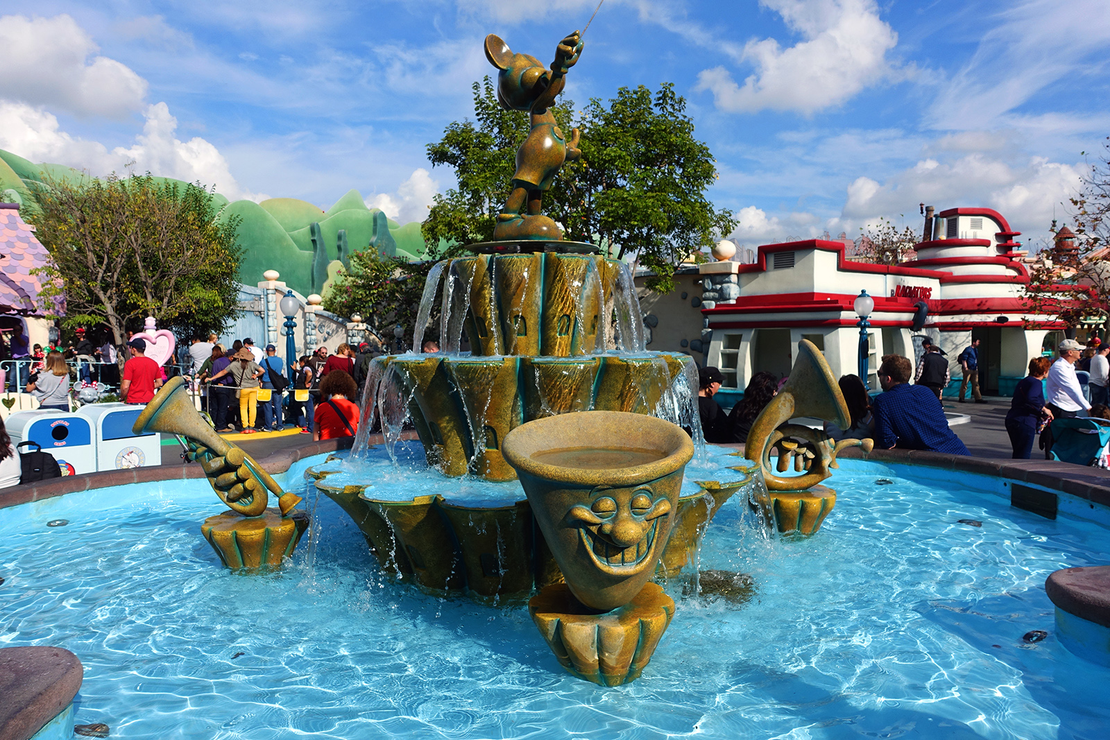 a fountain in a town filled with lots of people