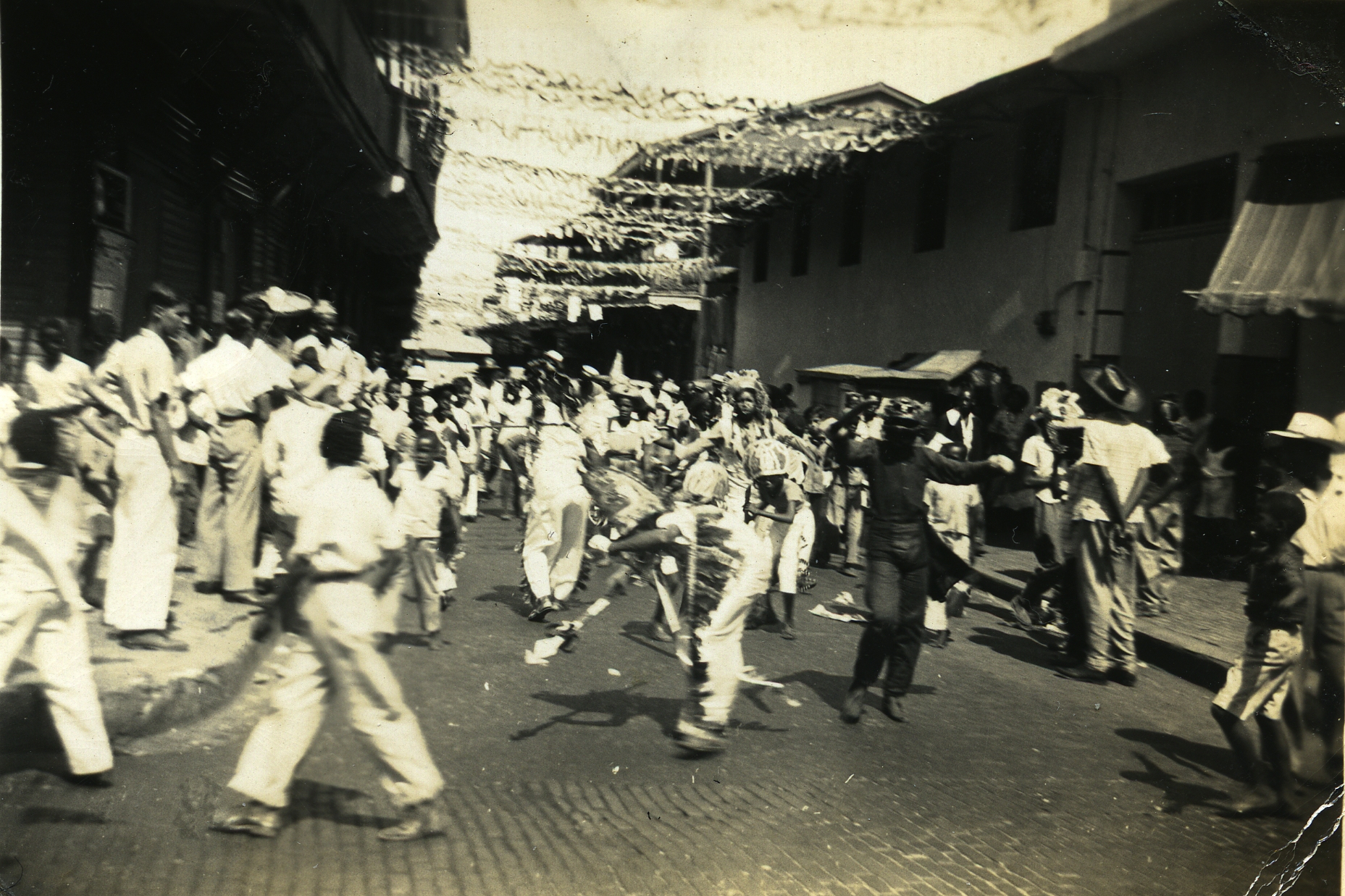 a group of people in street with many wearing hat