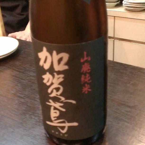 a bottle of wine with a japanese writing in the wine
