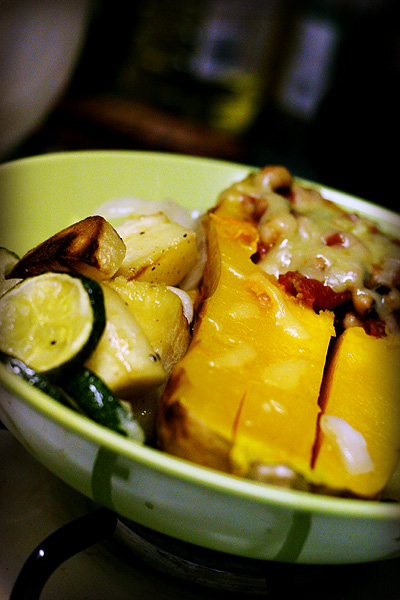 a yellow bowl full of food sitting on a table