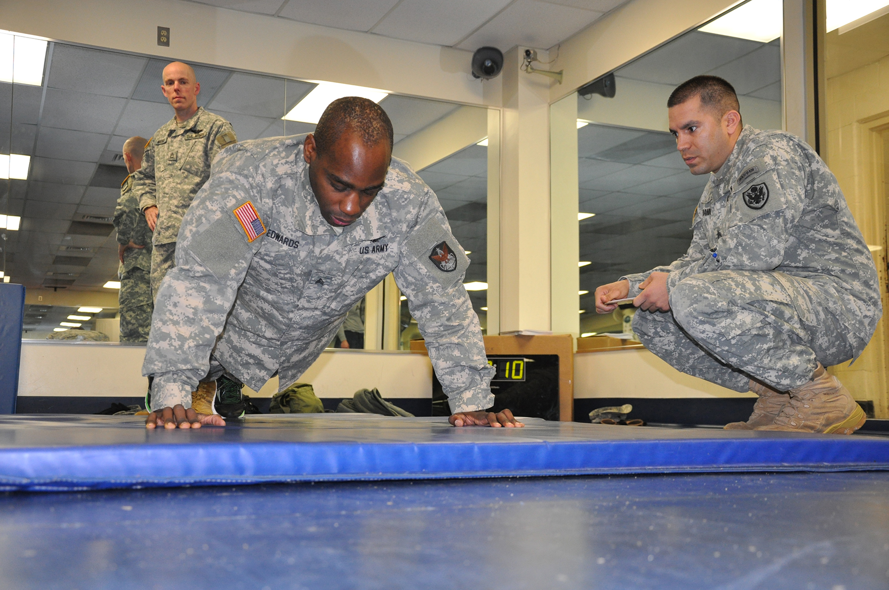 two men in military uniforms are playing on a blue table