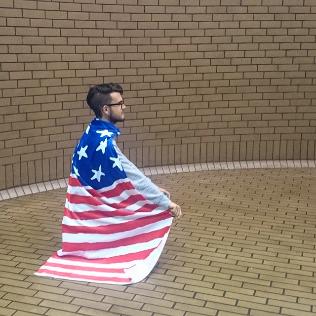 a man wearing a large american flag outfit on his back